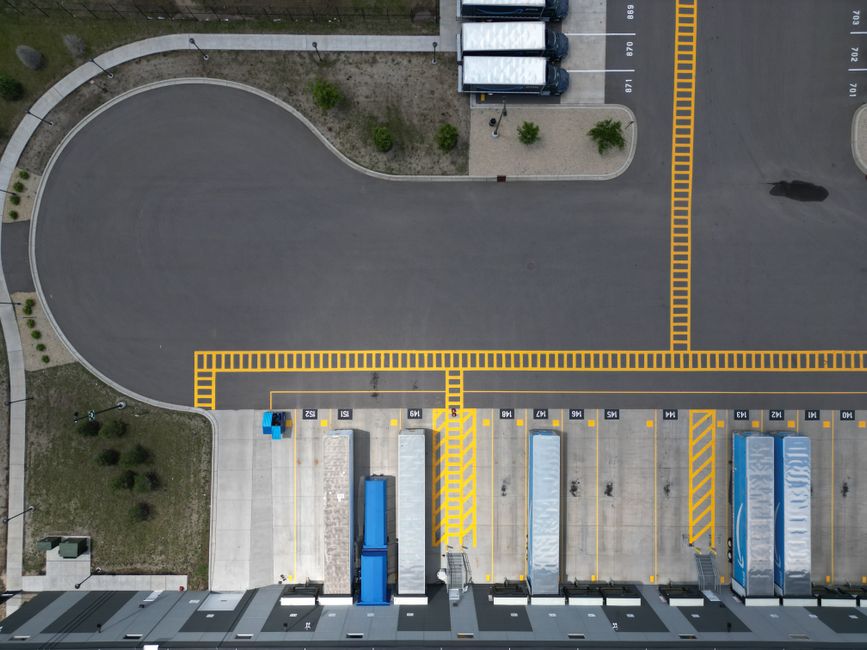 Overhead shot of a loading dock with trucks parked in an industrial area.